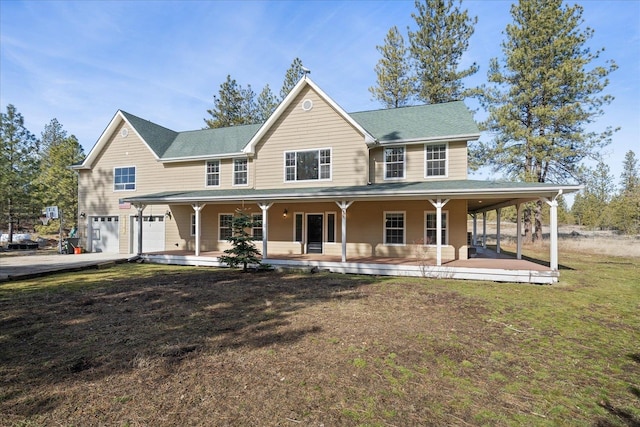 farmhouse inspired home with a garage, a porch, and a front yard