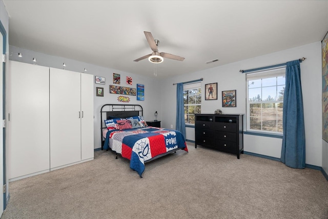 bedroom with a ceiling fan, baseboards, visible vents, and carpet flooring