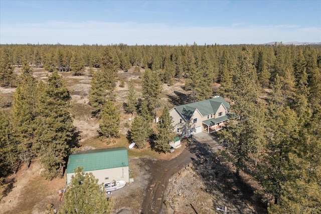 drone / aerial view featuring a forest view