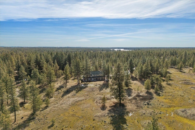 drone / aerial view featuring a forest view