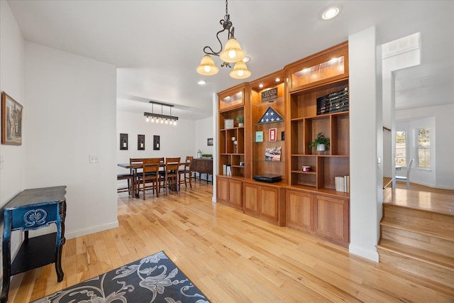 dining space with baseboards, an inviting chandelier, stairs, light wood-style floors, and recessed lighting