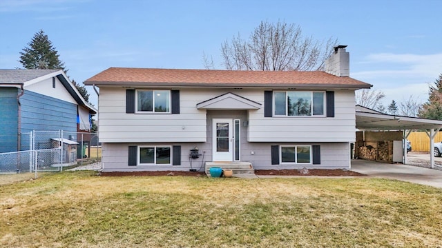 raised ranch with a chimney, fence, a carport, and a front yard