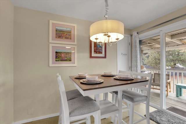 dining area with baseboards and a chandelier