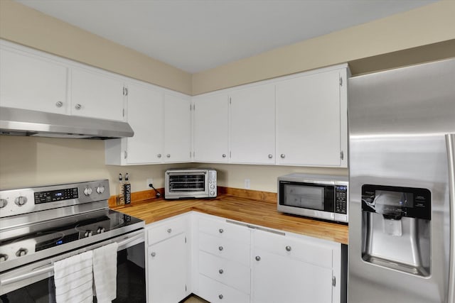 kitchen with a toaster, butcher block countertops, stainless steel appliances, under cabinet range hood, and white cabinetry