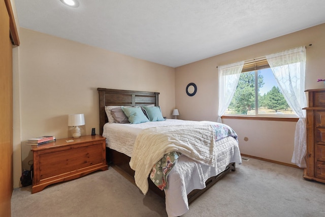 bedroom with carpet floors and baseboards