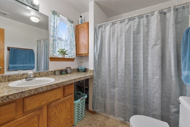 full bathroom with visible vents, a shower with shower curtain, toilet, vanity, and tile patterned floors