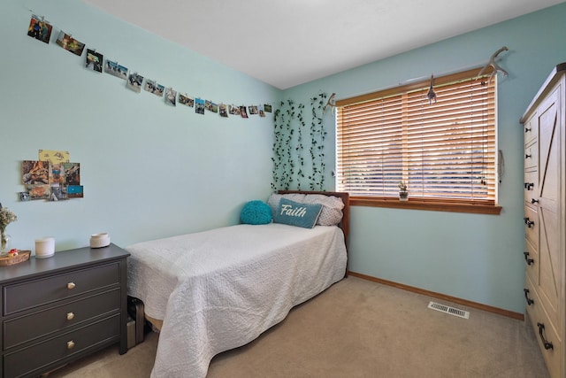 carpeted bedroom featuring visible vents and baseboards