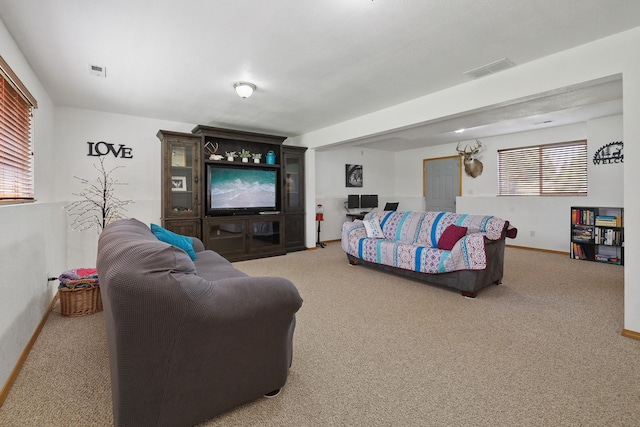 carpeted living room with visible vents and baseboards