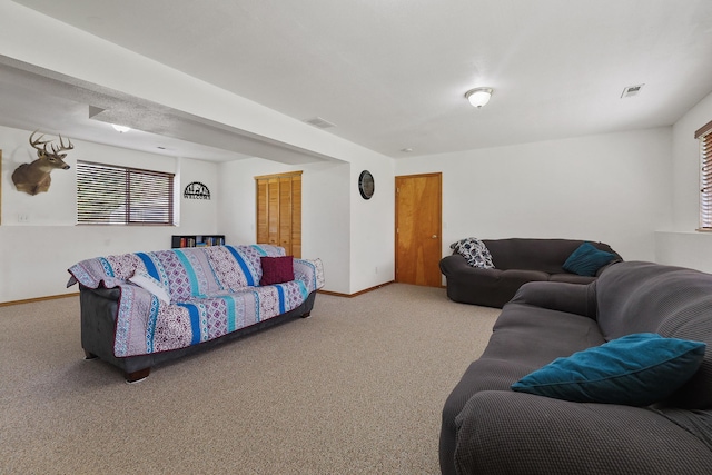 living room with carpet floors, baseboards, and visible vents