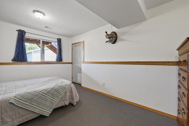 bedroom with carpet floors, baseboards, and visible vents