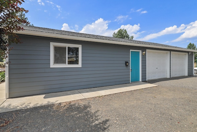 view of front of home featuring a garage and an outdoor structure