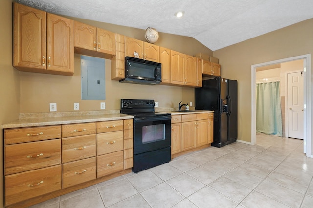 kitchen featuring a sink, vaulted ceiling, light countertops, electric panel, and black appliances