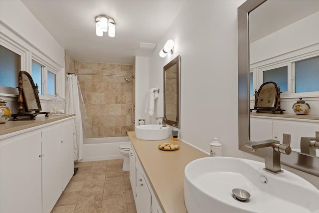 full bathroom featuring vanity, toilet, and shower / bath combo with shower curtain