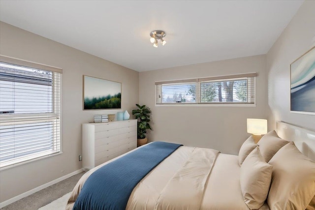 carpeted bedroom featuring baseboards