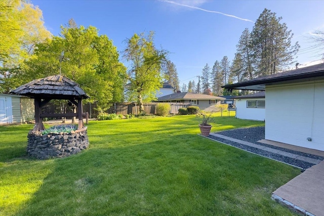 view of yard with fence and a gazebo