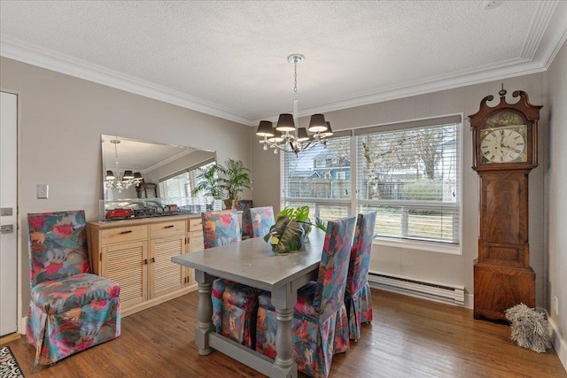 dining space with a notable chandelier, baseboard heating, and wood finished floors