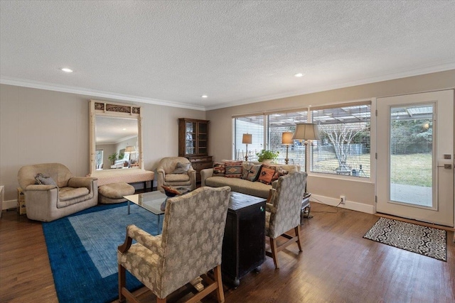 living room featuring plenty of natural light, crown molding, and wood finished floors