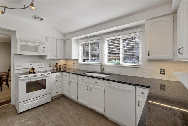 kitchen with white appliances, white cabinetry, visible vents, and a sink