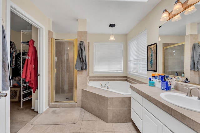 full bath with a spacious closet, a stall shower, and tile patterned floors
