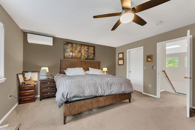 bedroom featuring light carpet, an AC wall unit, and baseboards