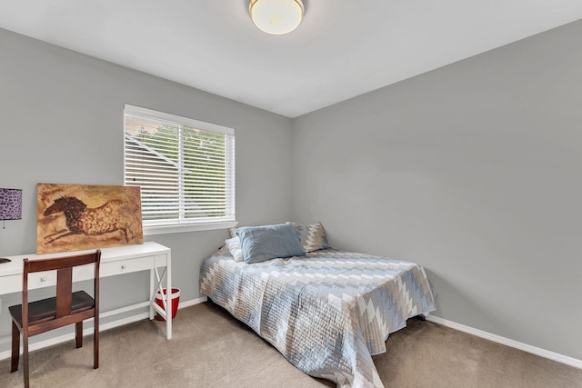 bedroom featuring light carpet and baseboards