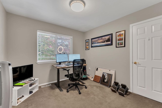 carpeted home office featuring visible vents and baseboards
