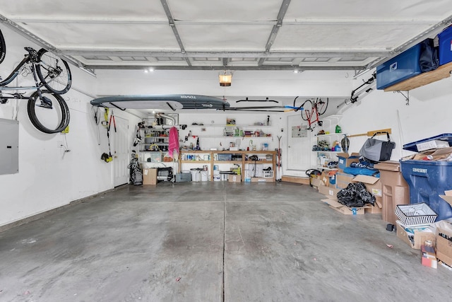 garage featuring electric panel and a workshop area