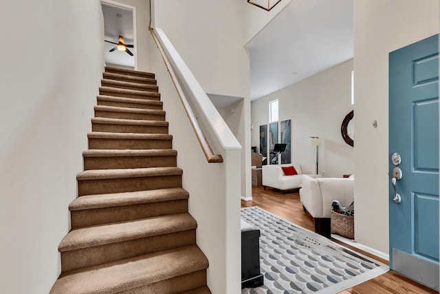 stairway with baseboards and wood finished floors