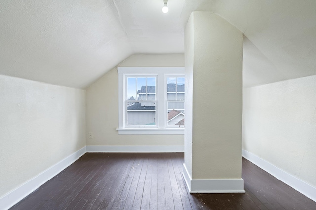 additional living space featuring lofted ceiling, wood-type flooring, and baseboards