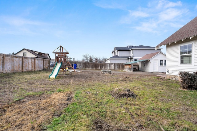 view of yard featuring a playground and a fenced backyard