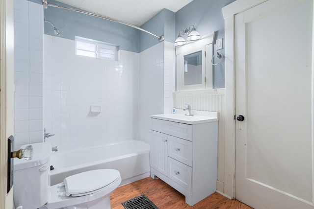 full bath with visible vents, toilet, washtub / shower combination, vanity, and wood finished floors