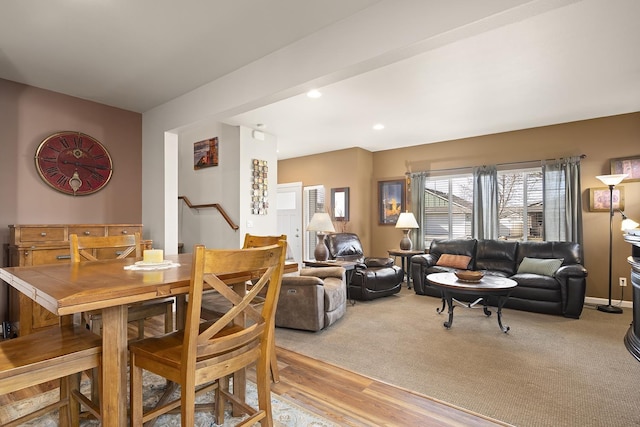 dining room featuring light wood-type flooring, stairs, and recessed lighting