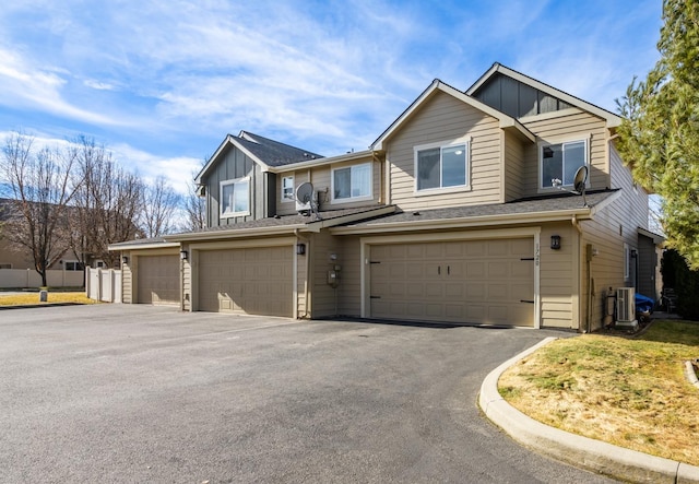 view of front of property with a garage, aphalt driveway, and board and batten siding