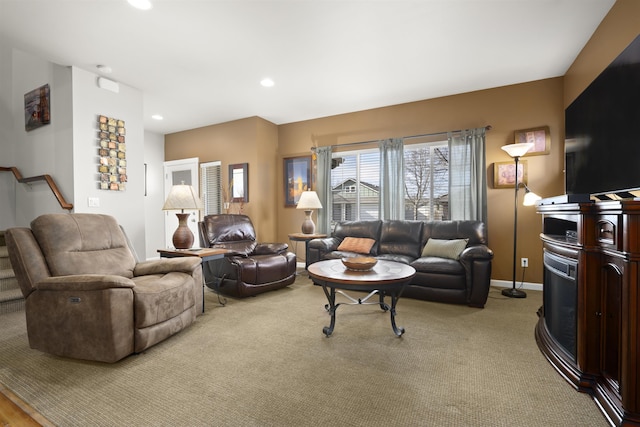 living area with stairs, recessed lighting, light colored carpet, and baseboards