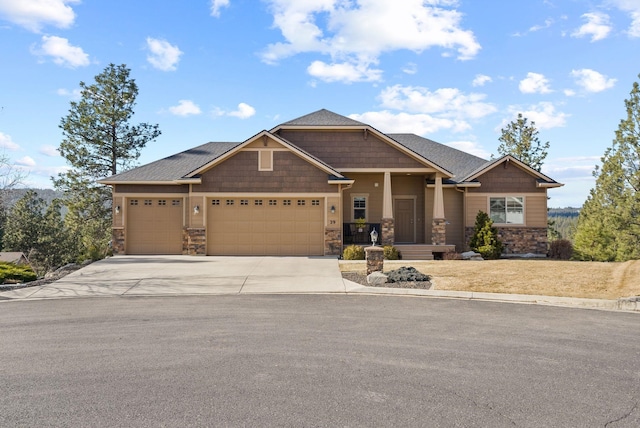 craftsman-style home with stone siding, concrete driveway, and an attached garage