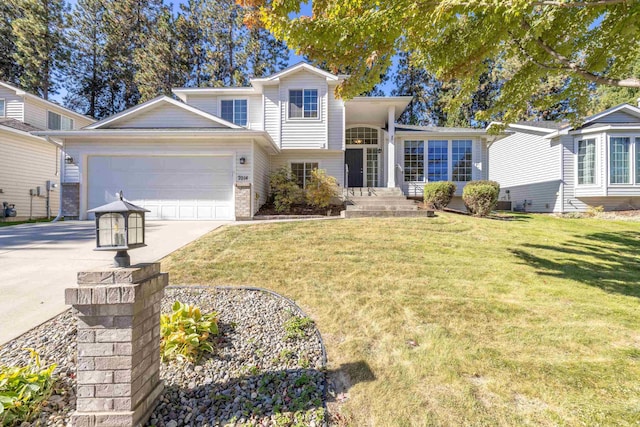 view of front of house with driveway, a garage, a front lawn, and brick siding