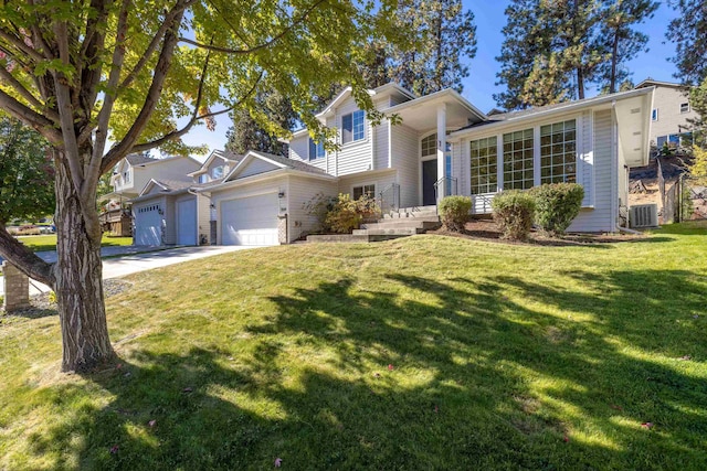 split level home featuring a garage, concrete driveway, a front lawn, and central air condition unit