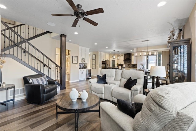 living area featuring beverage cooler, visible vents, dark wood finished floors, stairs, and recessed lighting