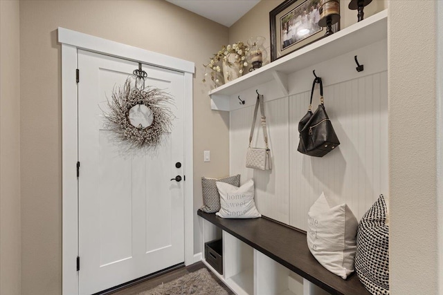 mudroom with dark wood finished floors