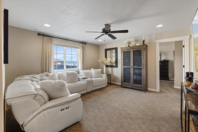 living room featuring baseboards, visible vents, and light colored carpet