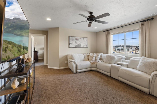 living room with a textured ceiling, ceiling fan, carpet floors, visible vents, and baseboards