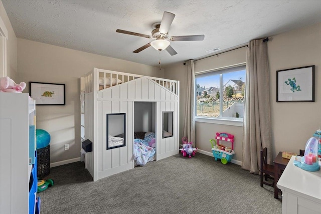 carpeted bedroom with visible vents, baseboards, ceiling fan, and a textured ceiling