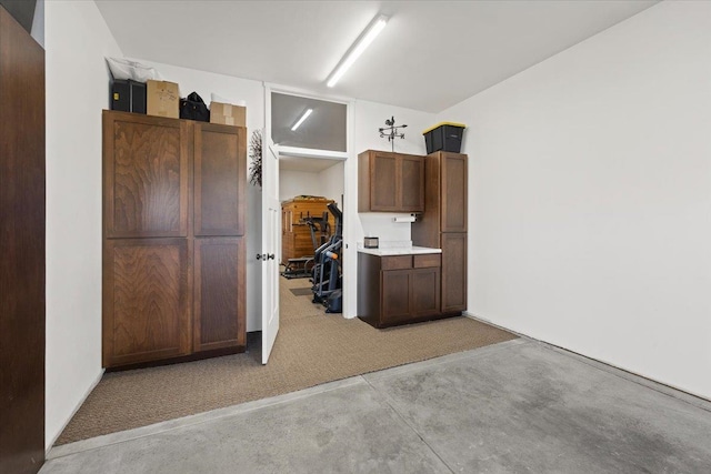 kitchen with light countertops and concrete flooring