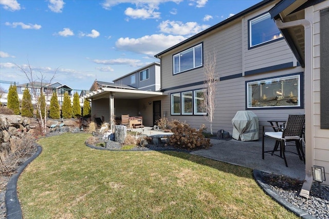 rear view of property with a patio area and a lawn