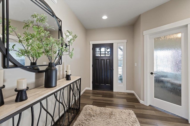 foyer with dark wood-style floors, baseboards, and recessed lighting