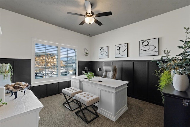 office area with a ceiling fan and wainscoting