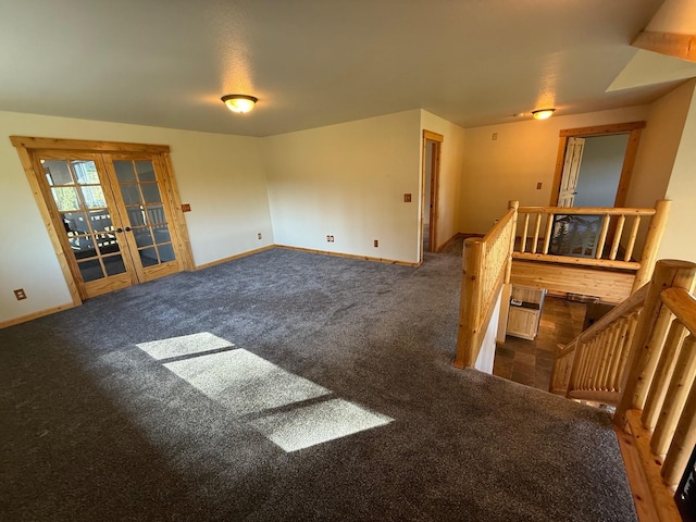 carpeted empty room with baseboards and french doors