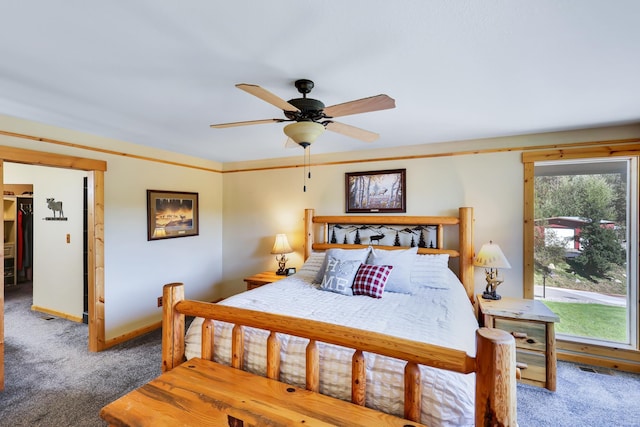 carpeted bedroom featuring multiple windows, baseboards, and a ceiling fan