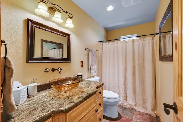 bathroom featuring toilet, a shower with shower curtain, and vanity