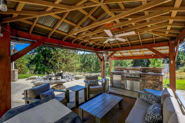 view of patio featuring an outdoor kitchen, a grill, an outdoor hangout area, and a gazebo